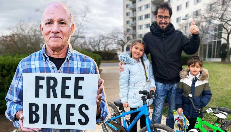a man holds a sign that says free bikes while a family stands behind him with blue and green bikes