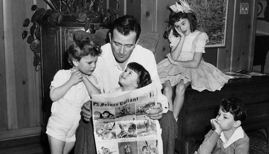 John Wayne reading to four of his children