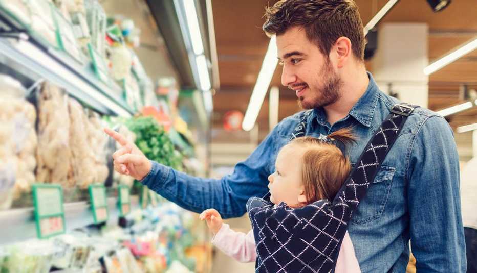 Baby wearing dad shopping at the grocery store