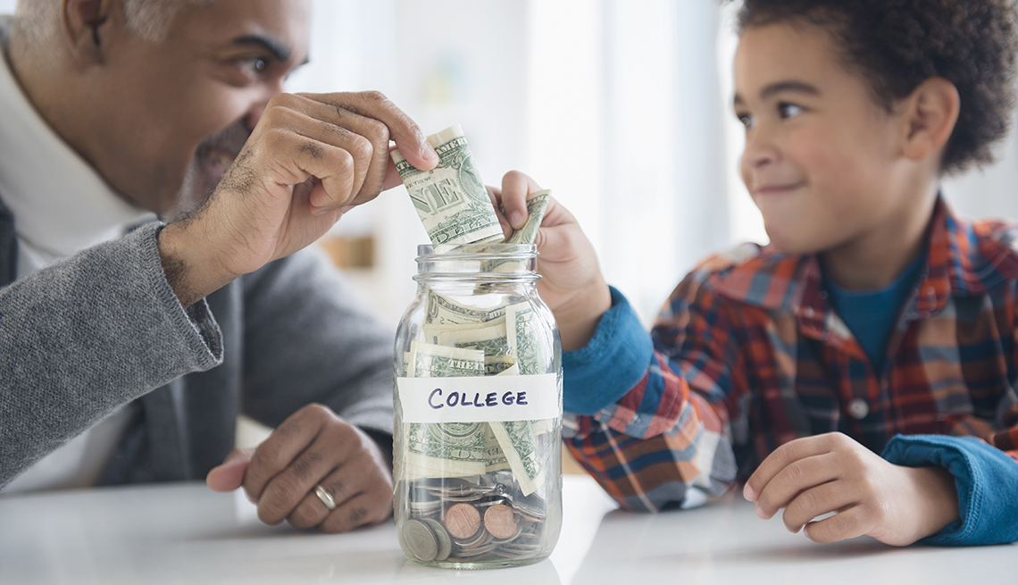 an older man and child putting money in a jar labeled "college"