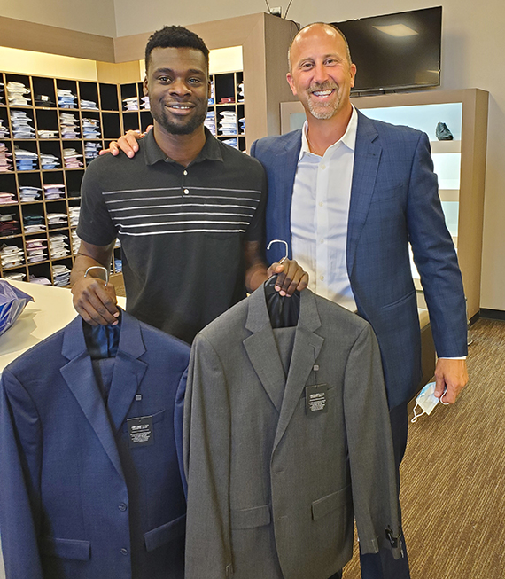 Impressed by Michael Phillips (left), who lived out of his car to save money and pay for his real estate license, Scot Johnston bought him a more professional wardrobe.