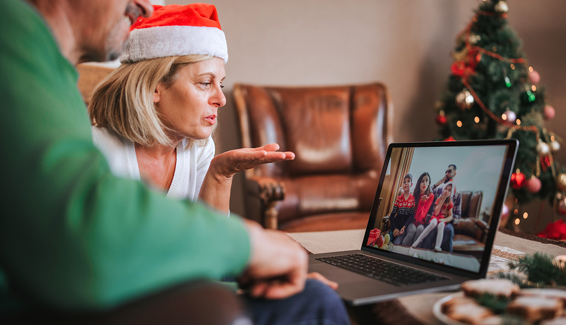 two people have a computer visit with family members during the holidays