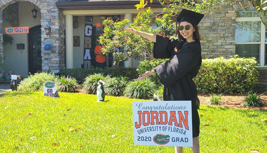 Jordan Kriseman poses in her front yard wearing her cap and gown