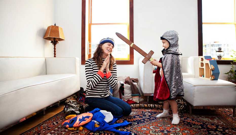 Mother and child playing. Child wearing a homemade knight costume