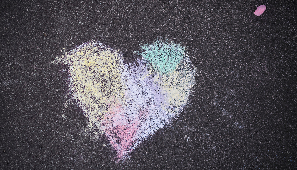 colorful heart shape drawn with sidewalk chalk on pavement