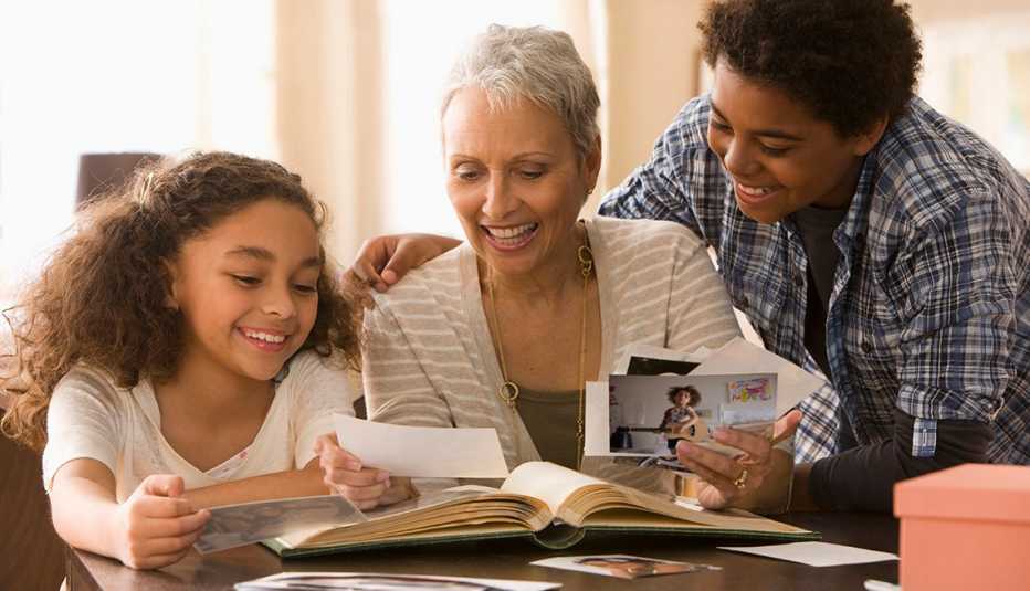 Grandmother and grandchildren looking at photographs 