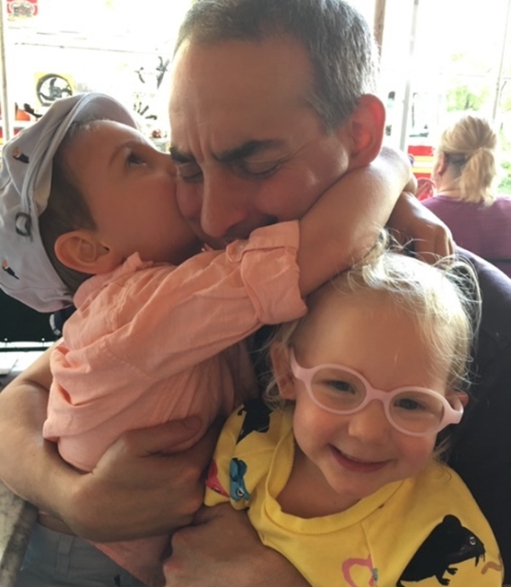 John Semel embracing children