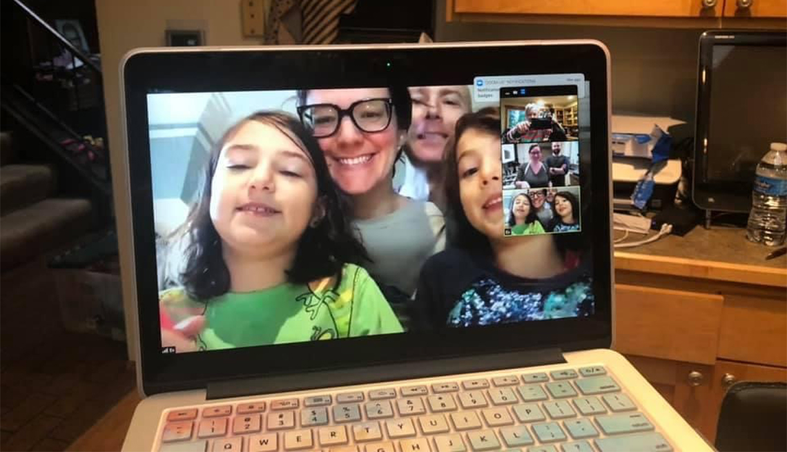 A family on a video chat via a laptop