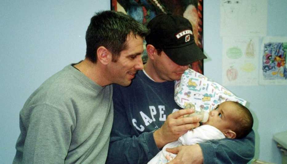 danny stewart left and peter mercurio right holding baby kevin