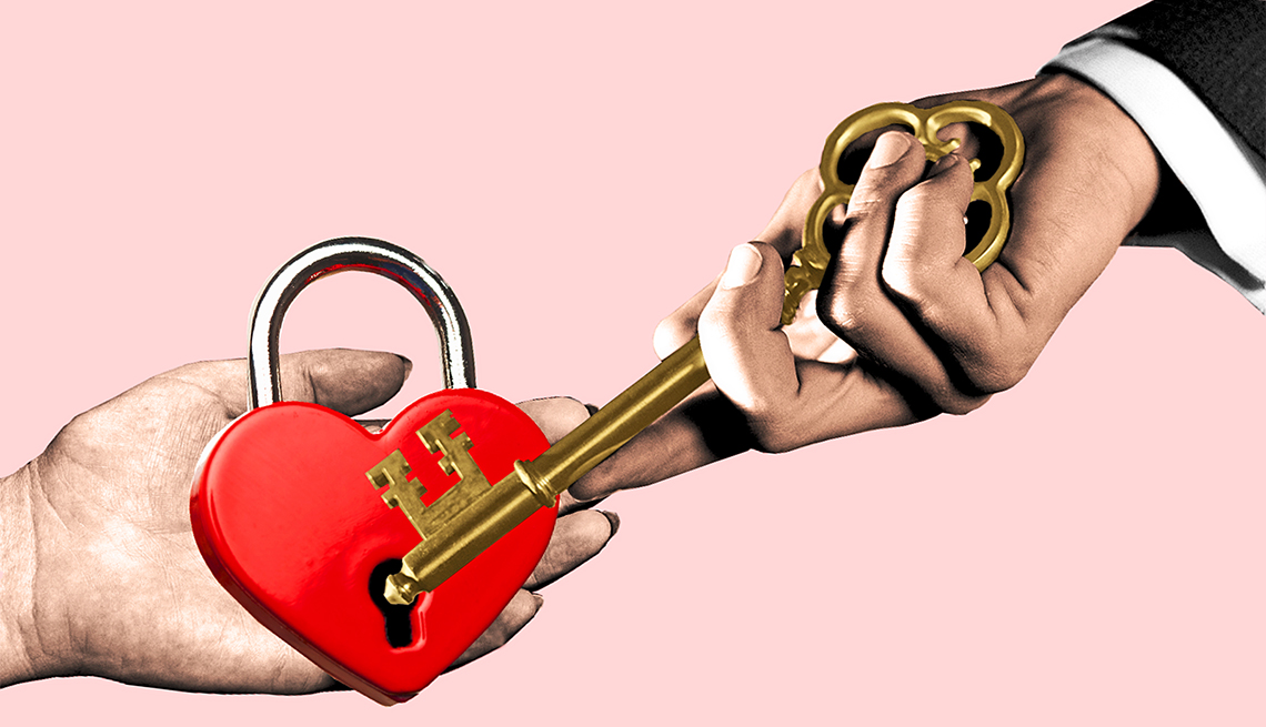 photo illustration of a womans hand holding a heart shaped lock and a mans hand holding a key that is trying to open the lock