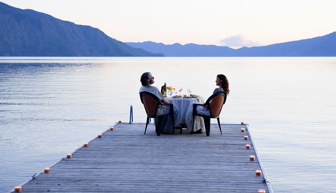 couple eating dinner on a pier