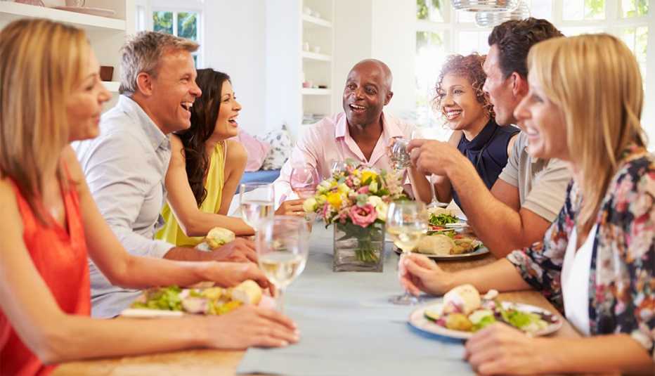 friends sitting around table at dinner party