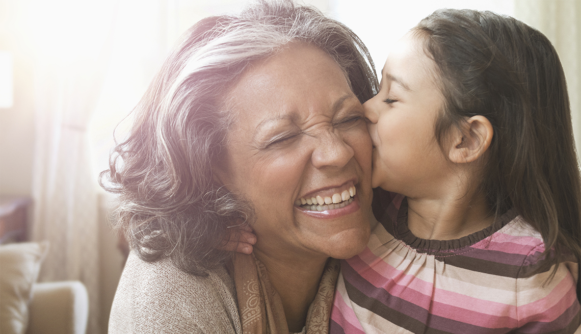 Granddaughter kissing cheek of grandmother