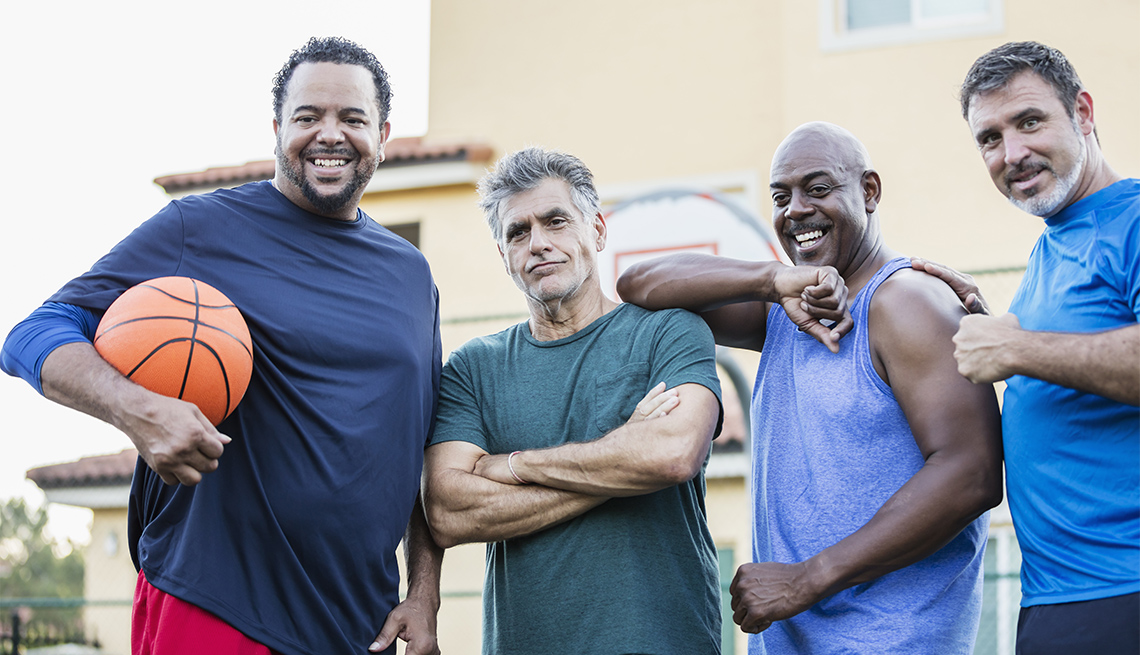 A multi-ethnic group of men on an outdoor basketball court