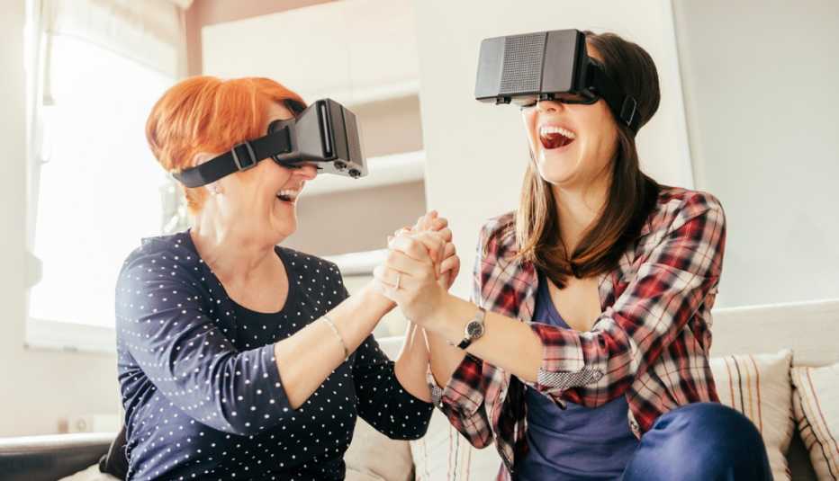two women playing a game together with virtual reality headsets