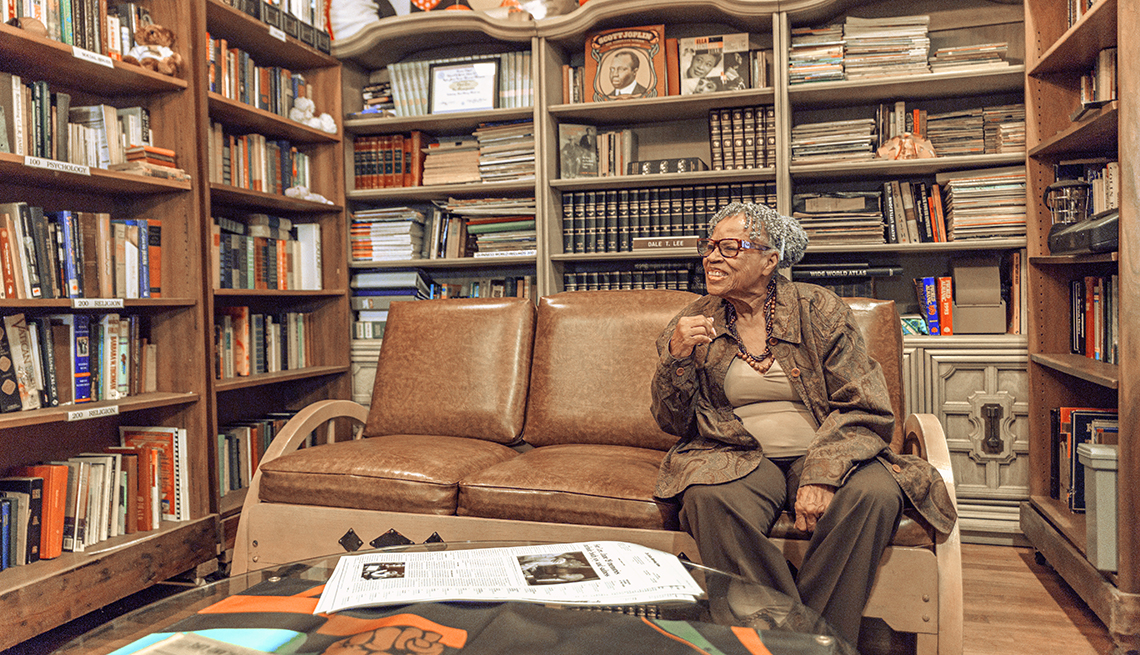 opal lee sits on a couch in her extensive home library