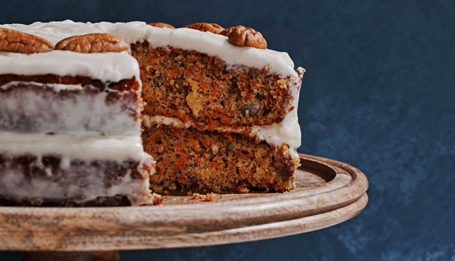 closeup of a beautiful carrot cake with a slice taken out