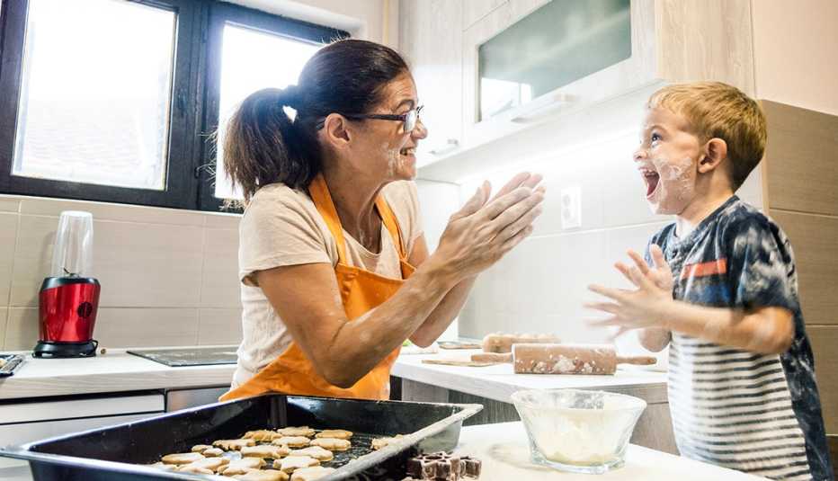 smiling grandmother baking with her happy grandson