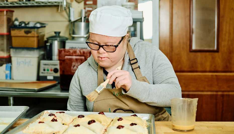 Eleanor Fluckiger prepares pastries during her work shift at The Bread Doctor bakery, in Torrington, Wyoming, Thursday, December 1, 2022. Eleanor’s father, Ezdan, who has held a career as a doctor, opened the bakery to ensure that Eleanor would have a job and thrive as an adult living with Downs Syndrome. 