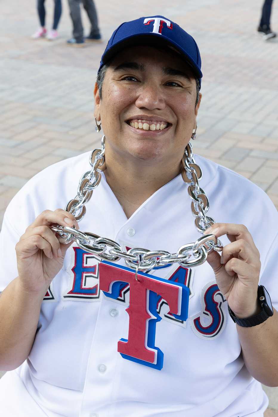 lisa jacklet wearing a chain with a large t on it