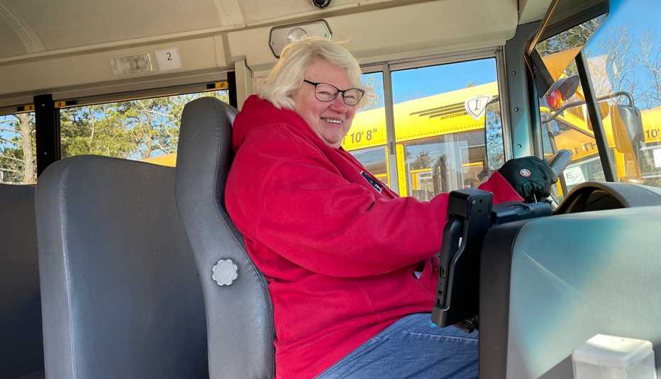 dorcas mcgurrin smiles in the drivers seat of a school bus