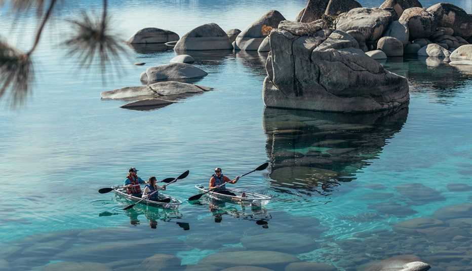 people kayaking in clear bottom boats on lake tahoe