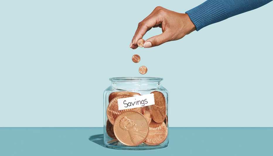 a man puts pennies in a jar marked savings