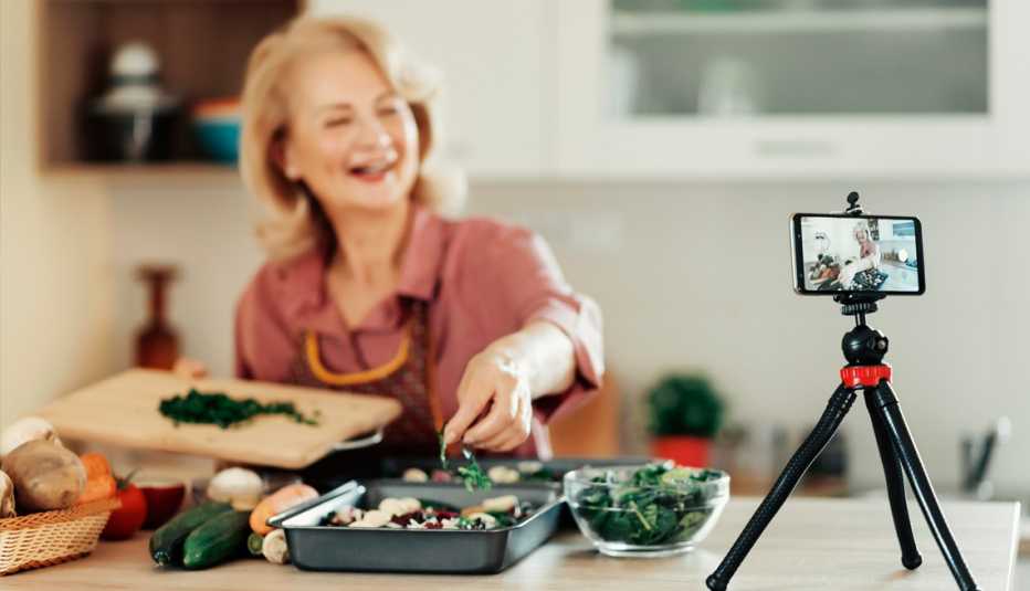 a woman recording herself cooking on her smartphone