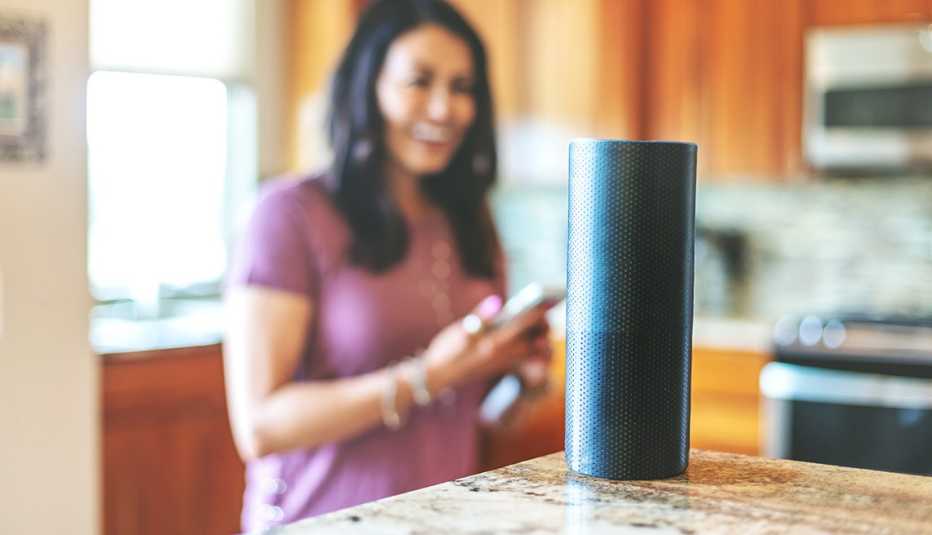 Operating smart speaker devices in her home through the use of smart phone