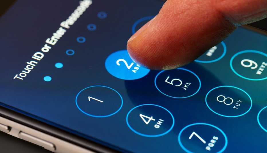 a person tapping in their passcode for their iphone