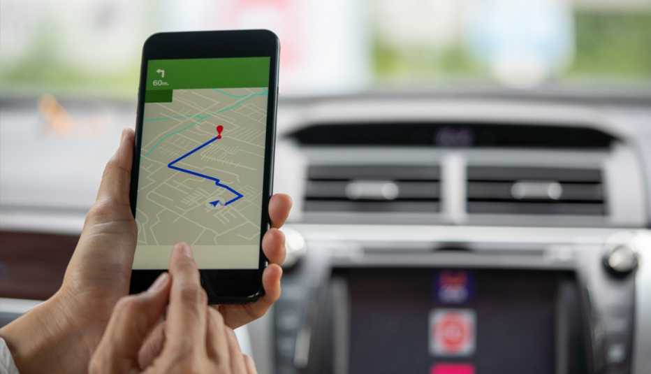 a person using a smartphone g p s in their car to map out a route