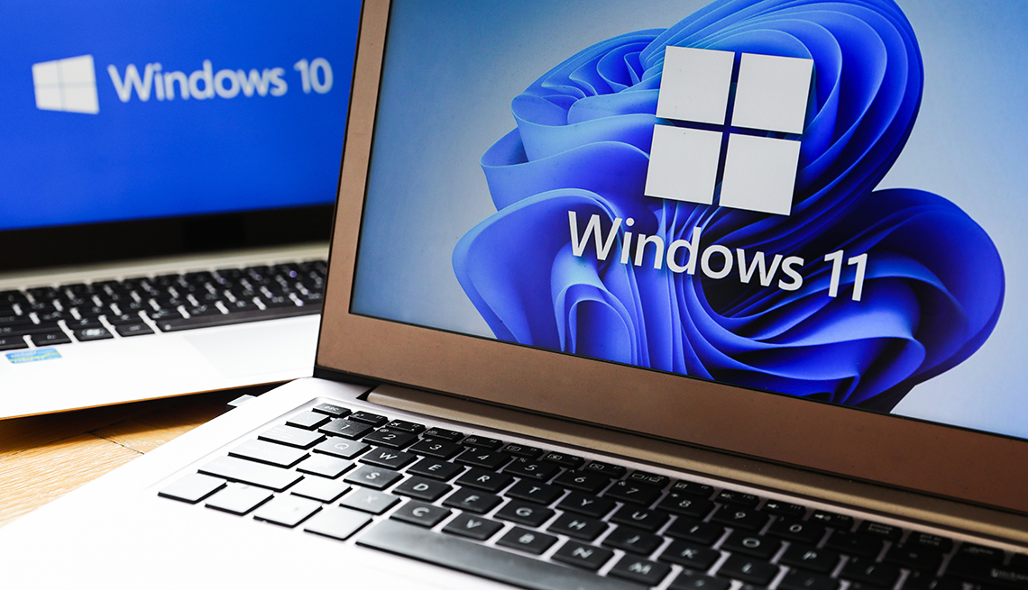 two laptops showing windows 11 and windows 10 operating system screens