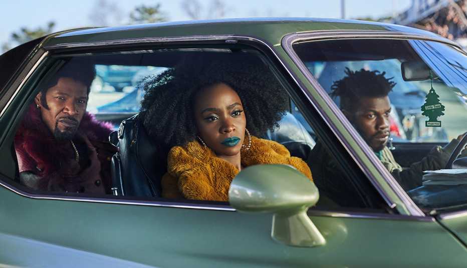 jamie foox teyonah parris and john boyega sitting in a car in the netflix film they cloned tyrone