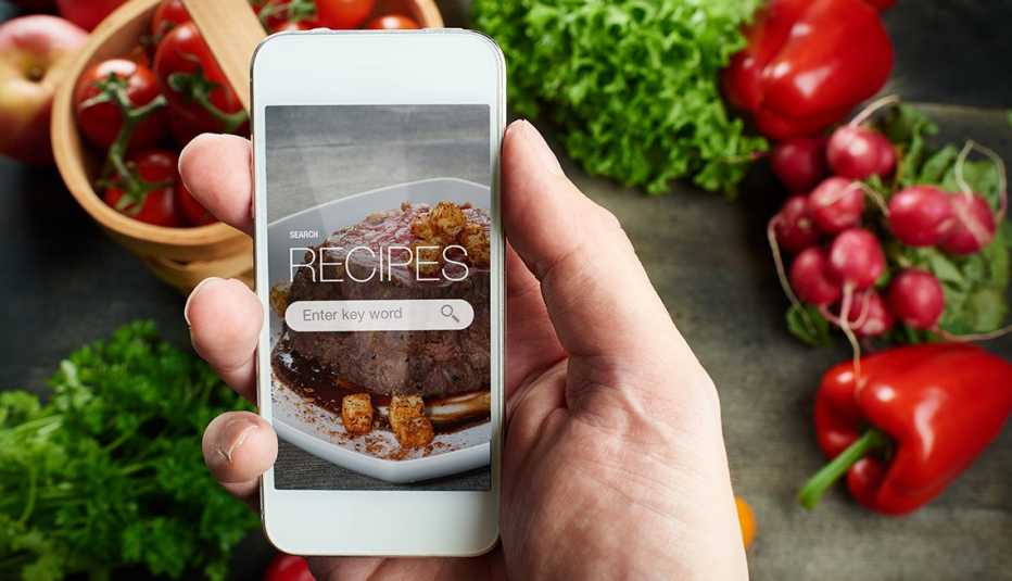 food recipes smartphone on rustic wooden table with vegetables