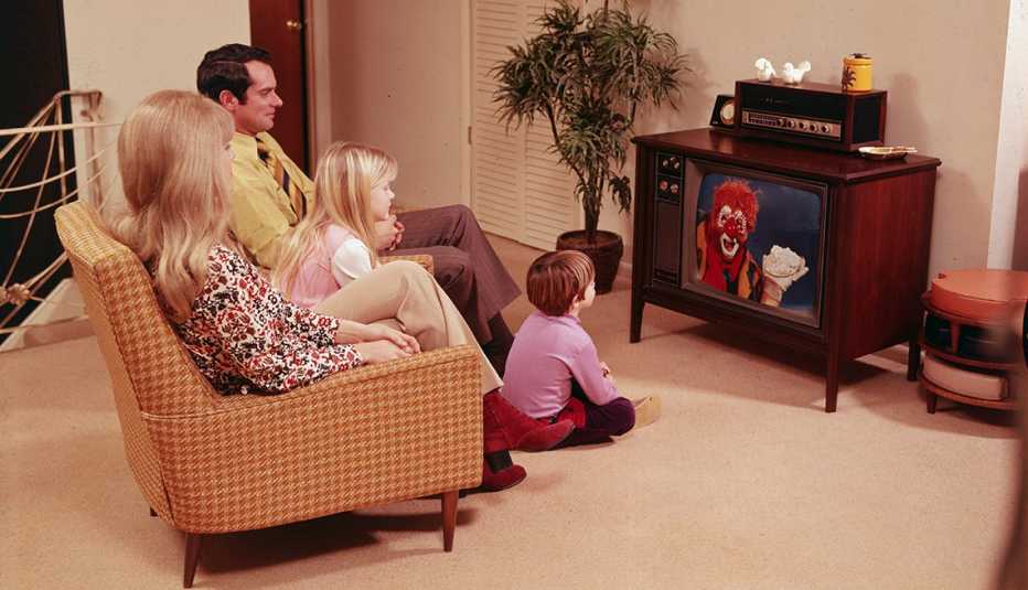 a 1970s era family watches a clown on television