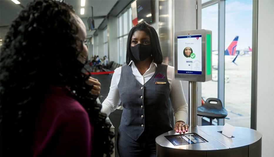 Woman using man using Delta Facial Recognition Technology at airport