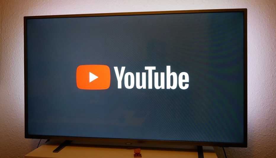 A general view of the YouTube logo displayed on a television screen