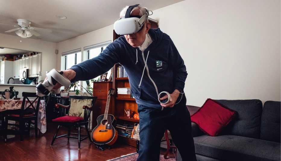a man in his living room playing virtual reality ping pong