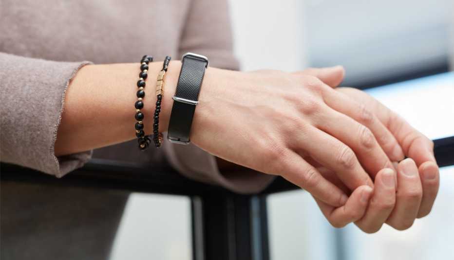 a woman wearing an aktiia blood pressure monitor on her wrist