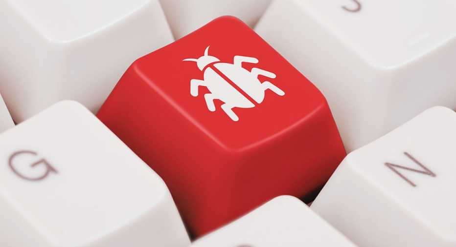 a red key on a white keyboard marked with a white bug