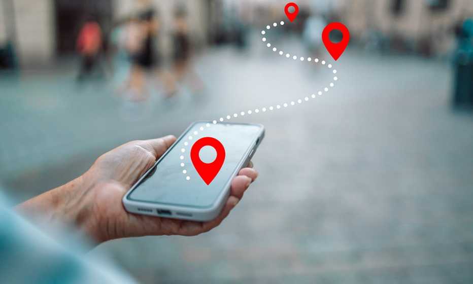 a person holds a smartphone displaying a navigation app with an illustration showing a map