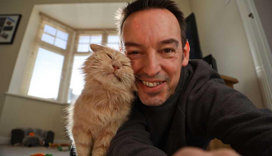 a man taking a selfie of himself and his cat