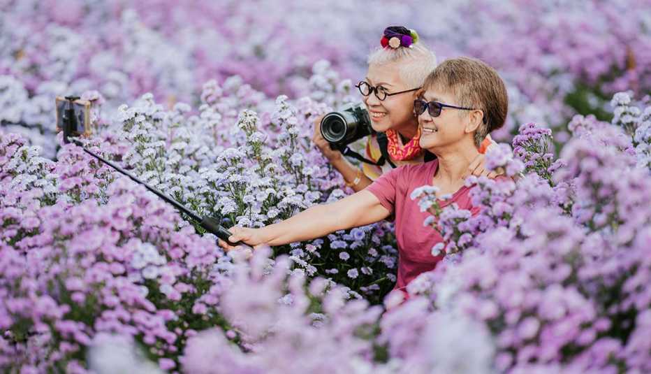 two women in a field of flowers taking a selfie
