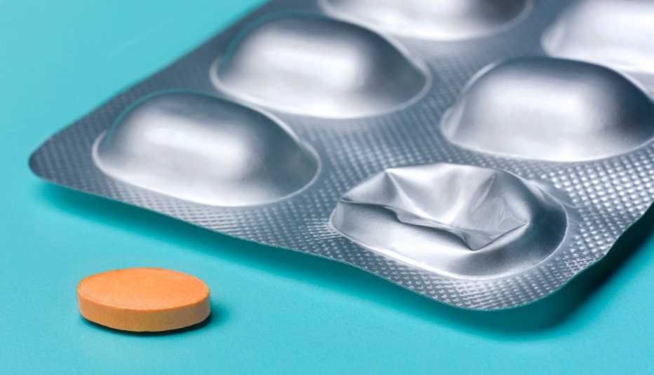 pill removed from blister pack ready to take