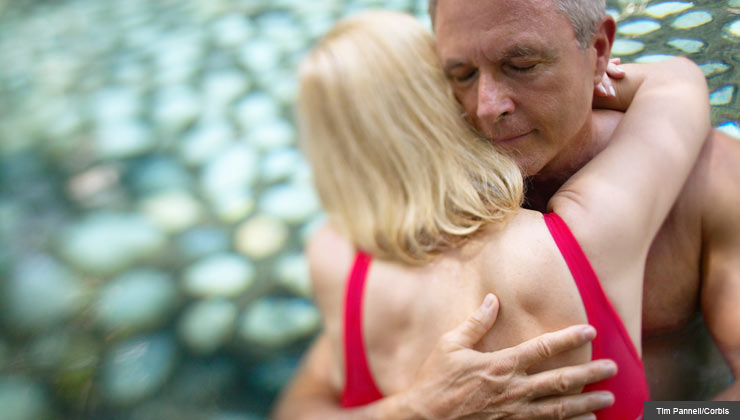 Couple embrace in a pool-Sex is healthy for older men