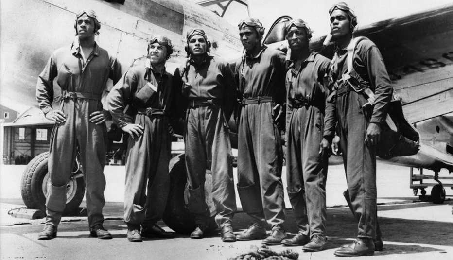 George Iles, third from left, with fellow Tuskegee Airmen and a Curtiss P-40 Warhawk.
