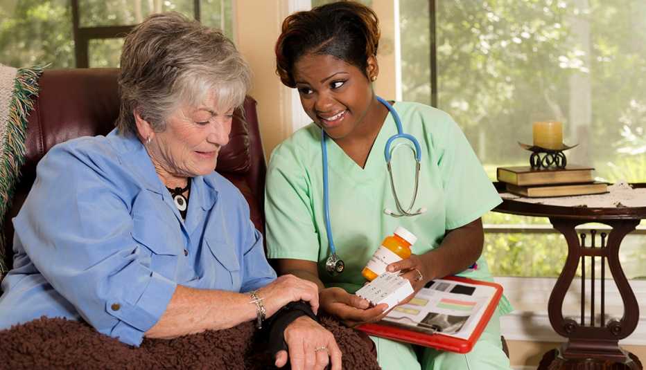 nurse showing woman prescriptions