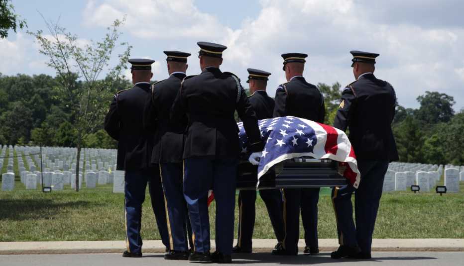 Members of the U.S. Army's 3rd Infantry Regiment "The Old Guard" carry the flag-draped casket of World War II Army veteran Carl Mann to his final resting place during his funeral on the 75th anniversary of the D-Day invasion June 6, 2019 at Arlington Nati