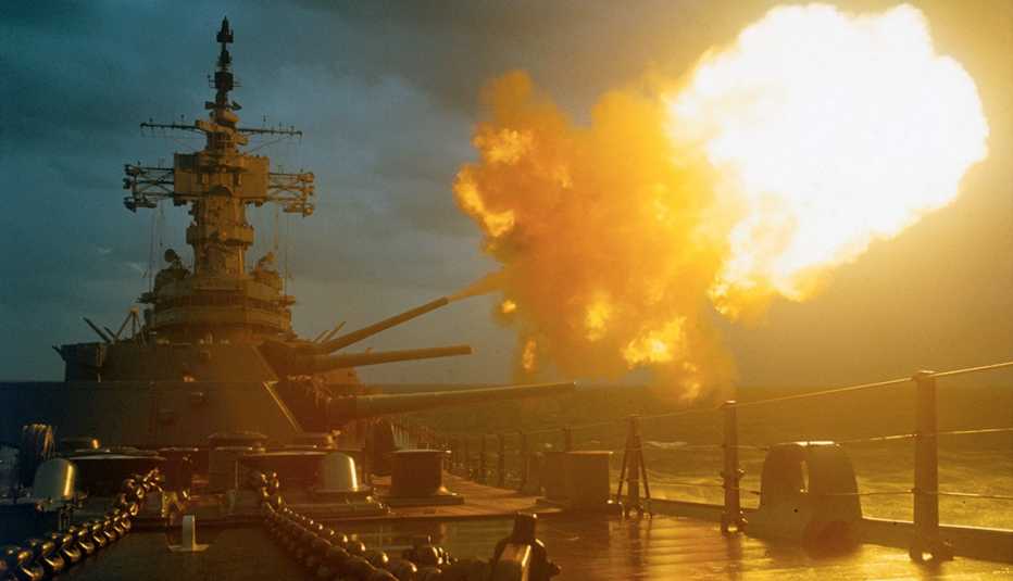 A battleship fires its guns