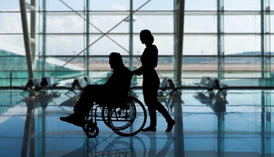 a person is pushing a wheelchair through an airport